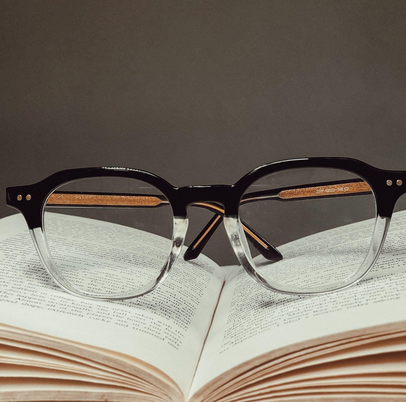 black framed eyeglasses on book page